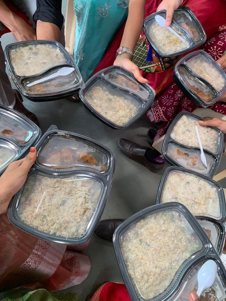 Team members gathered around a table of Chatkharay Express dishes