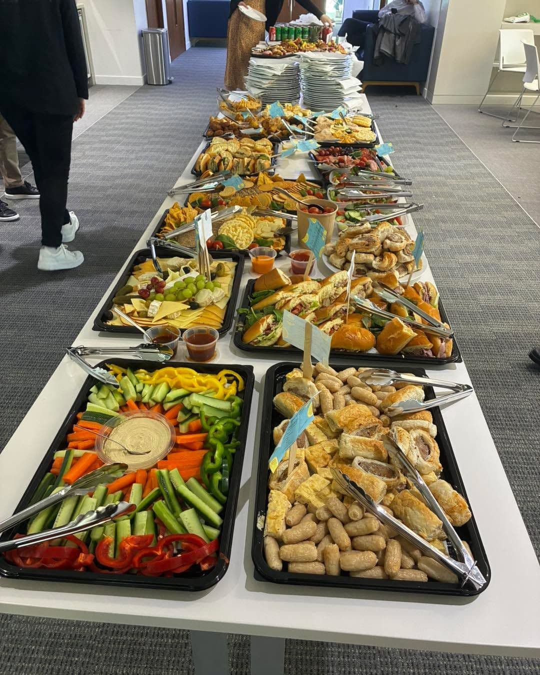 Office team serving themselves from a Chatkharay Express catering spread